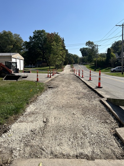 A dirt path on side of street marked by construction cones in Wadsworth Ohio