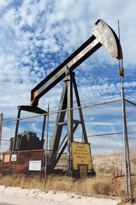 oil rig behind a wired fence in Sandhills State Park