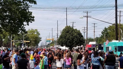 Hundreds of residents gather in street milling around the annual food truck festival