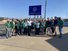 A group of Hosted America employees celebrate ribbon cutting 