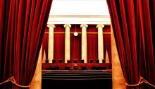 Red carpet curtains frame the inside of the Supreme Court hearing room