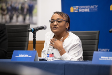 Belinda Parker-Mendoza speaks behind a microphone at an Opportunity Home event