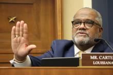 Congressman Troy Carter, D-LA holds his hand up while questioning a witness at Congressional oversight committee hearing
